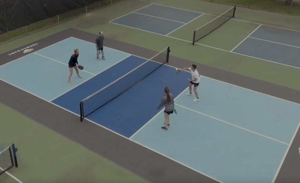 Four people playing pickleball on Pickleball Performance Tile
