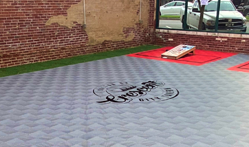 Cornhole Court with Custom Logo Painted on it