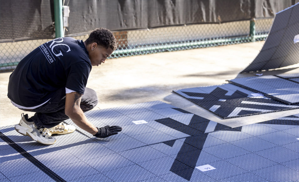 RG team member securing backyard court tiles together