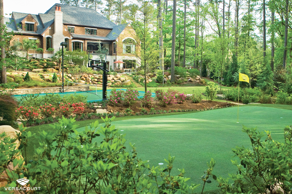 Large backyard with a putting green and multi-sport game court