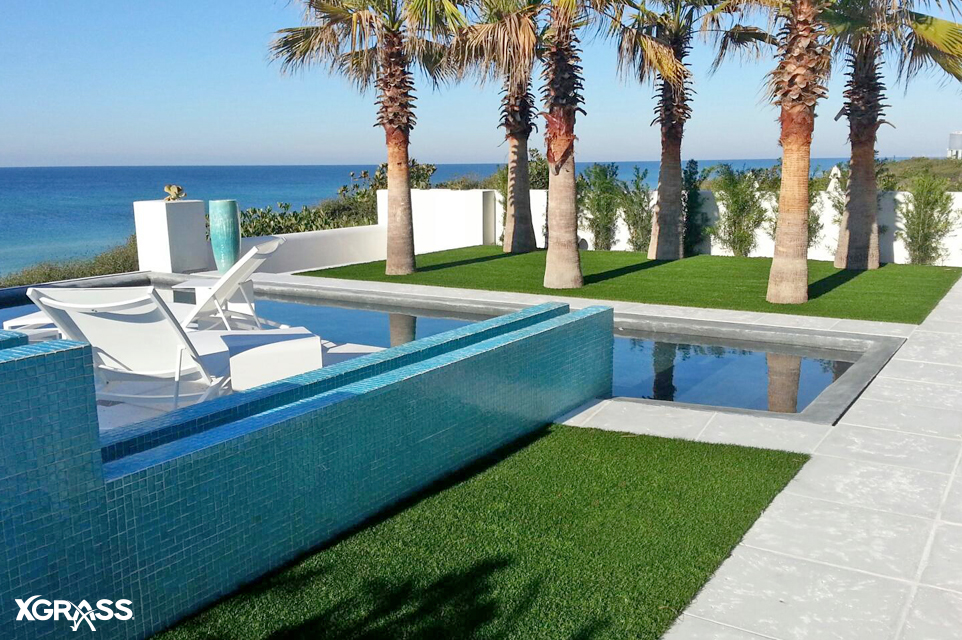 Backyard pool with artificial grass lawn installed