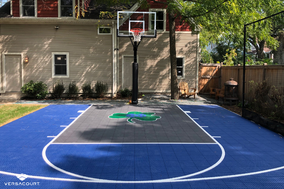Small backyard installed with blue and gray basketball half-court