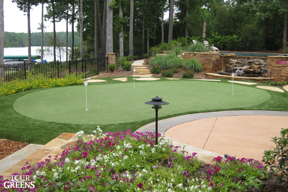 Backyard with a tour quality putting green installed from Tour Greens
