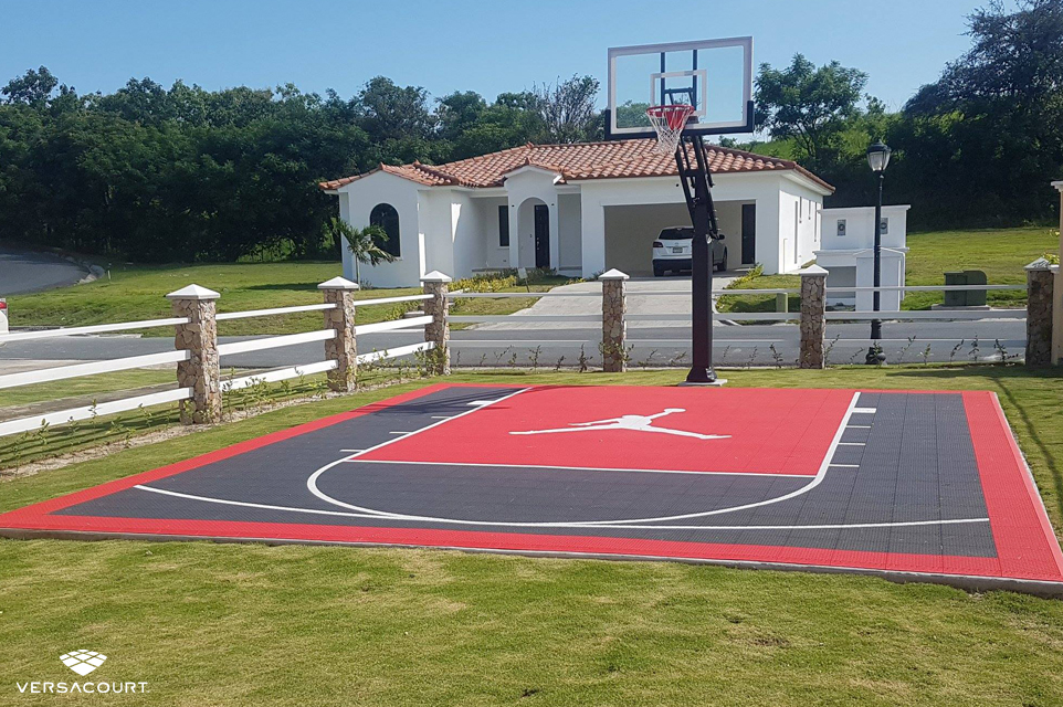 Small backyard basketball court with a custom logo