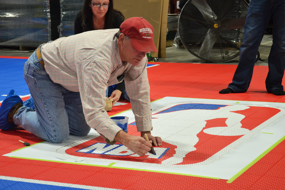 Person Painting Custom Logo on Red VersaCourt
