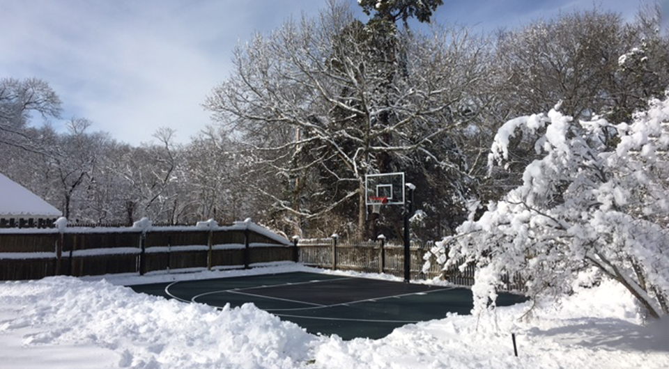 Green and black court under snow