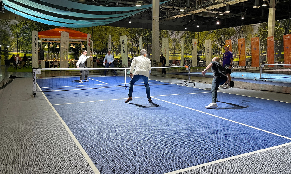 Poeple playing on a rental pickleball court at business conference center