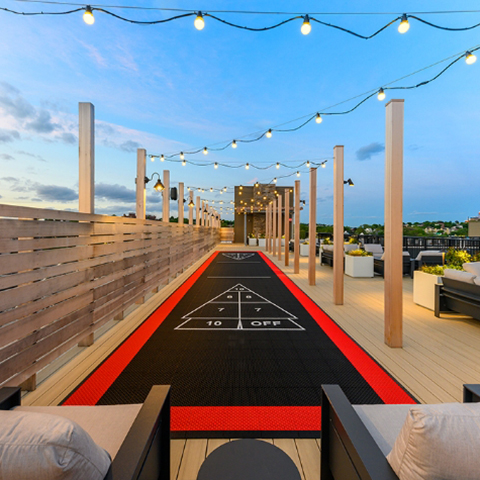 a rooftop shuffleboard court adds entertainment in lounge areas