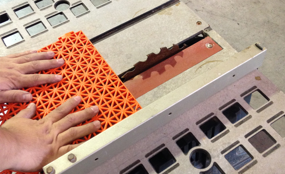 Trimming orange VersaCourt tile with a table saw