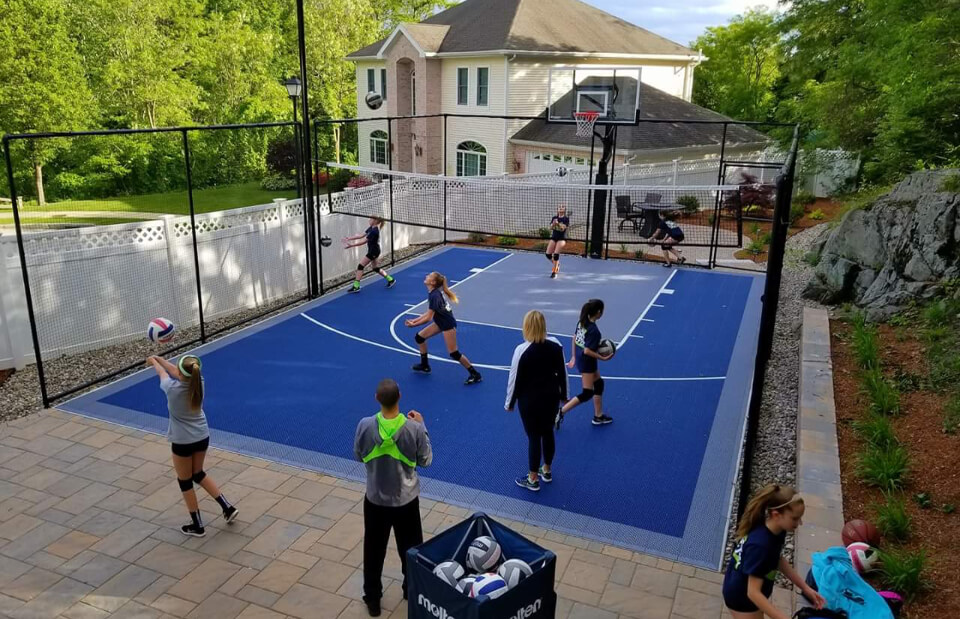 volleyball players practicing on a backyard VersaCourt game court