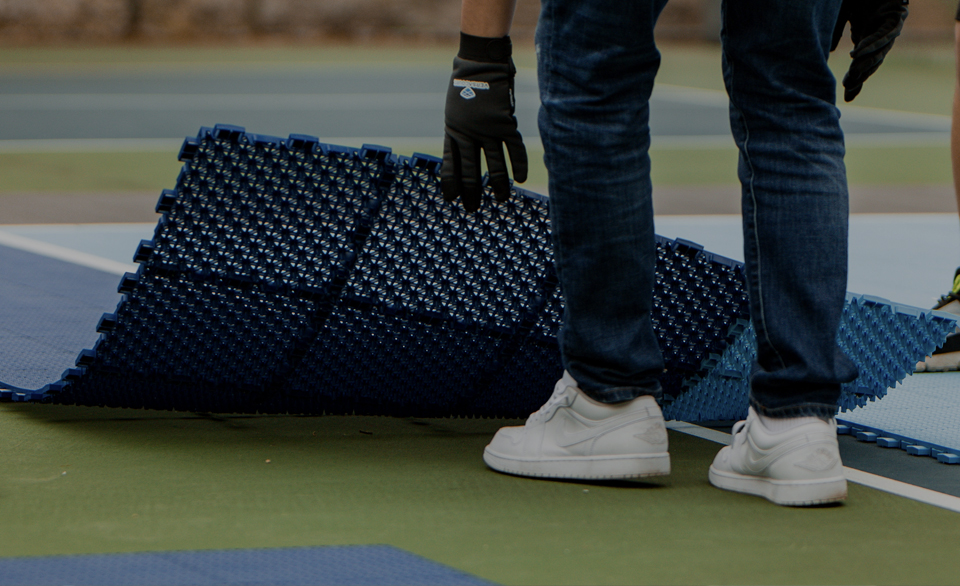 Still image of two Pickleballs bouncing on different courts